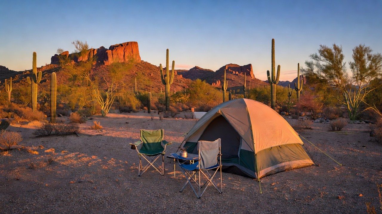 Family campsite in the Sonoran Desert at golden hour with saguaro cacti and red rock mountains behind