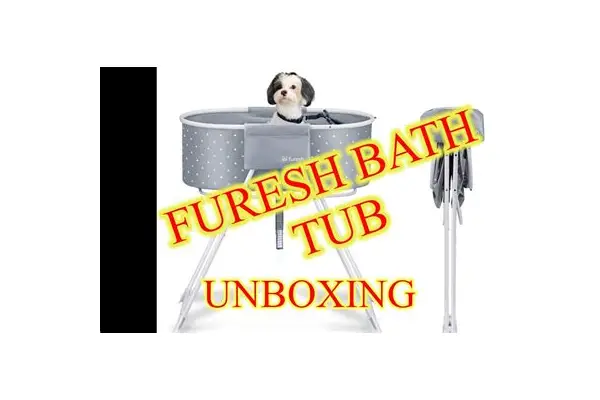 Dog being washed in the elevated Furesh bath tub with drain hose